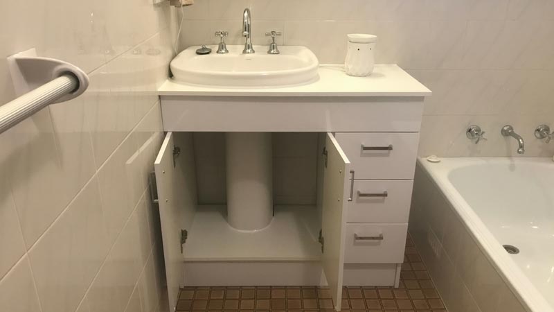 Custom built a vanity storage unit around clients free standing sink.